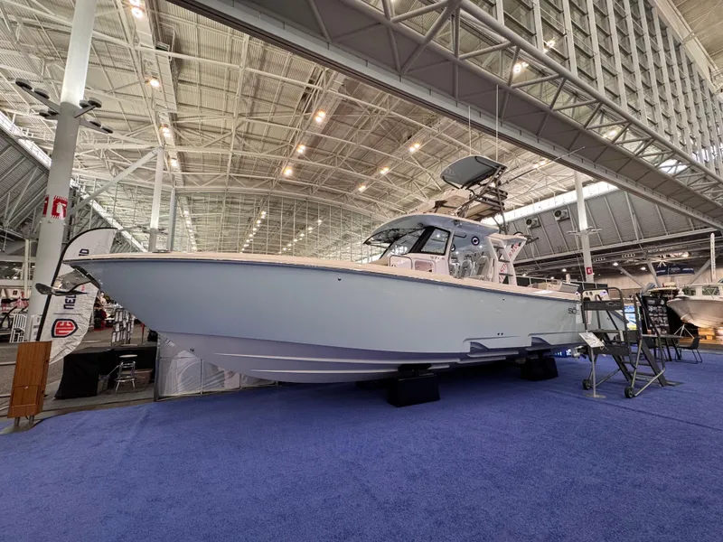 Slide: The Image of 2025 Solace 37 CS boat displayed indoors on blue carpet. - 1