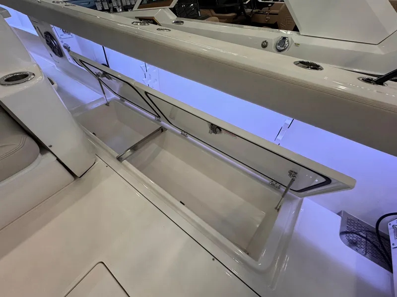 Slide: The Image of 2025 Solace 37 CS boat storage compartment with blue LED lighting. - 12