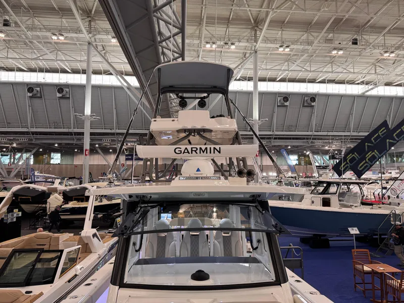 Slide: The Image of 2025 Solace 37 CS boat displayed at an indoor boat show. - 15