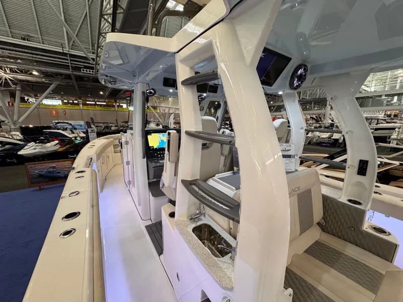 Slide: The Image of 2025 Solace 37 CS luxury boat interior with modern helm and seating at a boat show. - 5