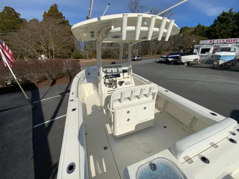 Slide: The Image of 2024 Cobia 240 Center Console boat in a parking lot, showcasing spacious deck and seating. - 10