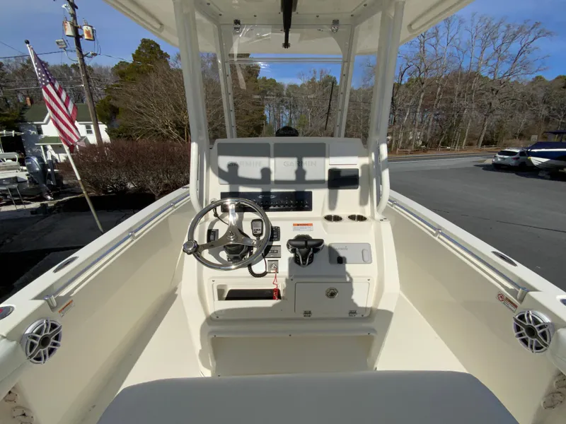 Slide: The Image of 2024 Cobia 240 Center Console boat interior with steering wheel and control panel. - 11