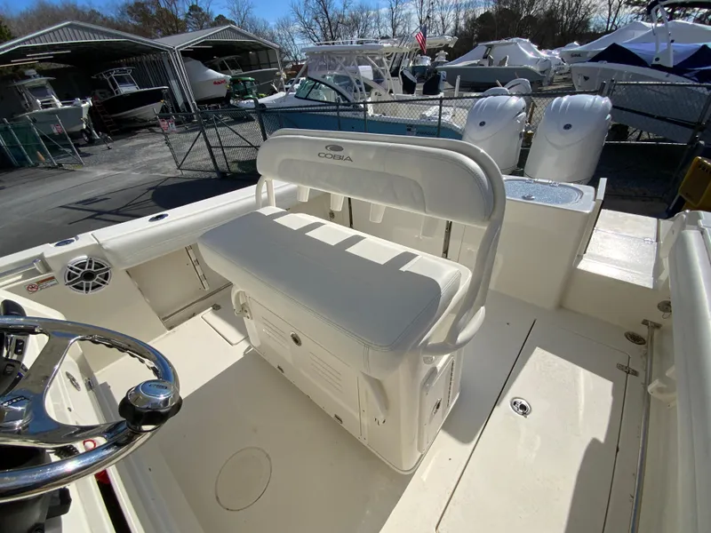 Slide: The Image of 2024 Cobia 240 Center Console boat interior with seating and steering wheel. - 13