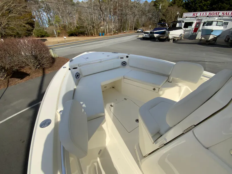 Slide: The Image of 2024 Cobia 240 Center Console boat with spacious seating, parked outdoors. - 19