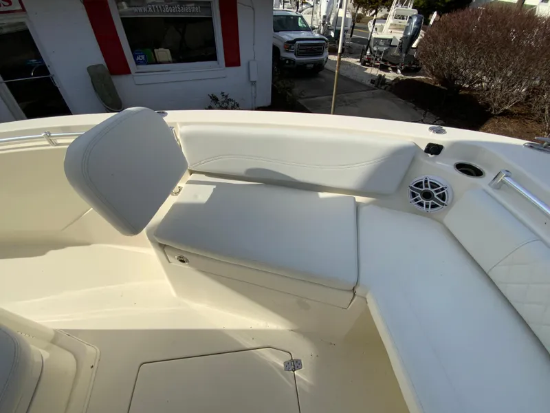 Slide: The Image of 2024 Cobia 240 Center Console boat interior with cushioned seating and speaker. - 20