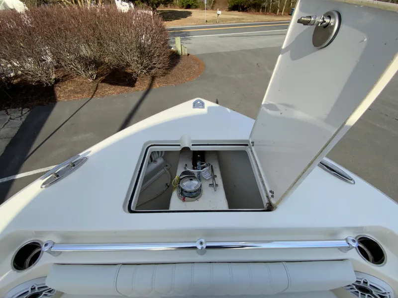 Slide: The Image of 2024 Cobia 240 Center Console boat with open storage compartment on deck. - 23