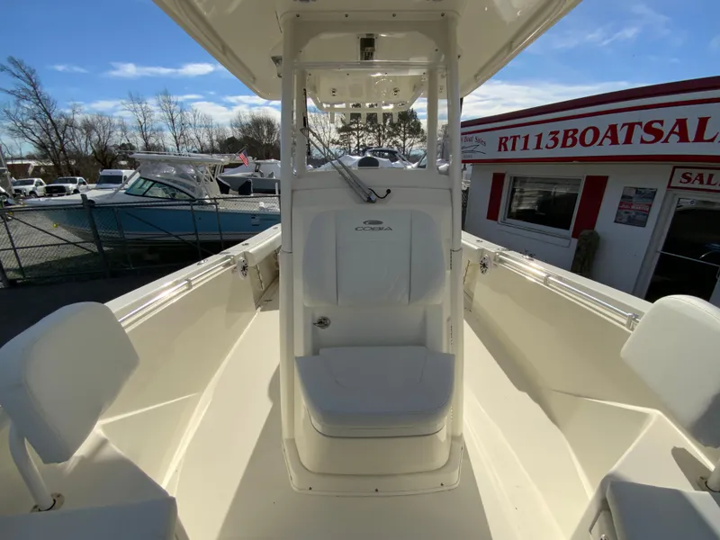 Slide: The Image of 2024 Cobia 240 Center Console boat at dealership, sunny day. - 24