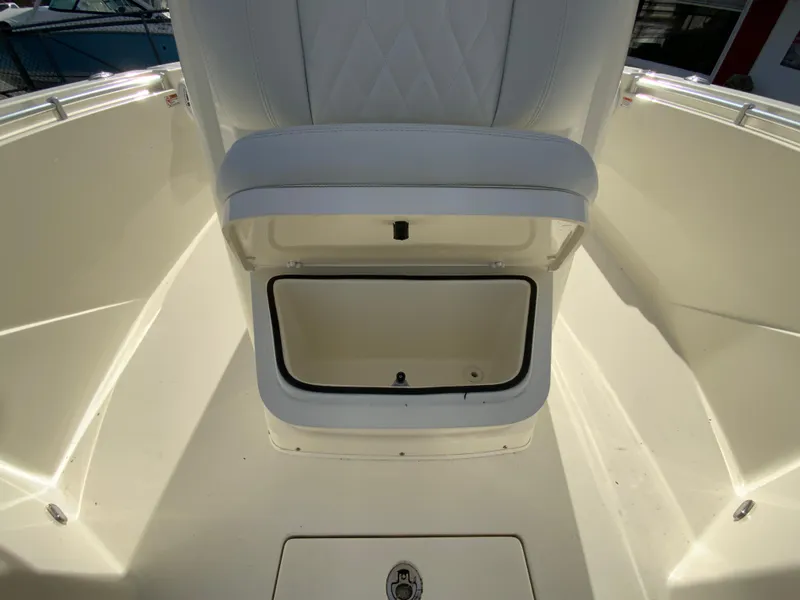Slide: The Image of 2024 Cobia 240 Center Console boat with open storage compartment. - 25