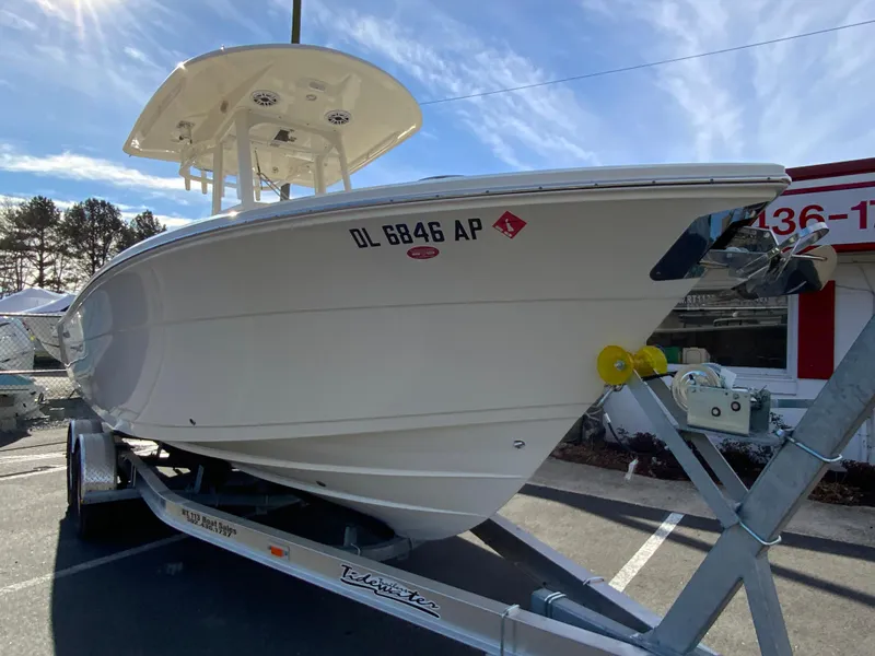 Slide: The Image of 2024 Cobia 240 Center Console boat on trailer, parked outdoors. - 3