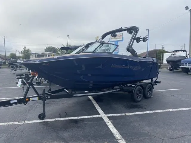 The Image of 2025 MasterCraft NXT21 boat on trailer in parking lot. - 0