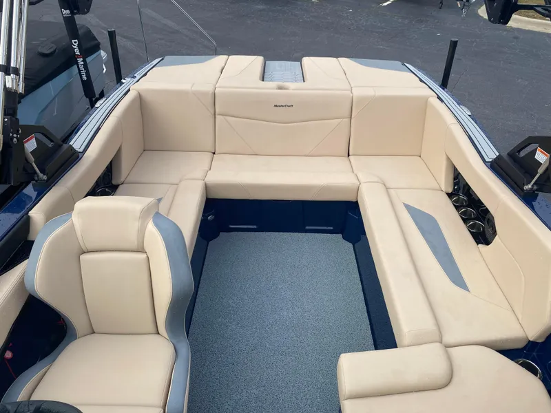 Slide: The Image of 2025 MasterCraft NXT21 boat interior with beige seating and modern design. - 9