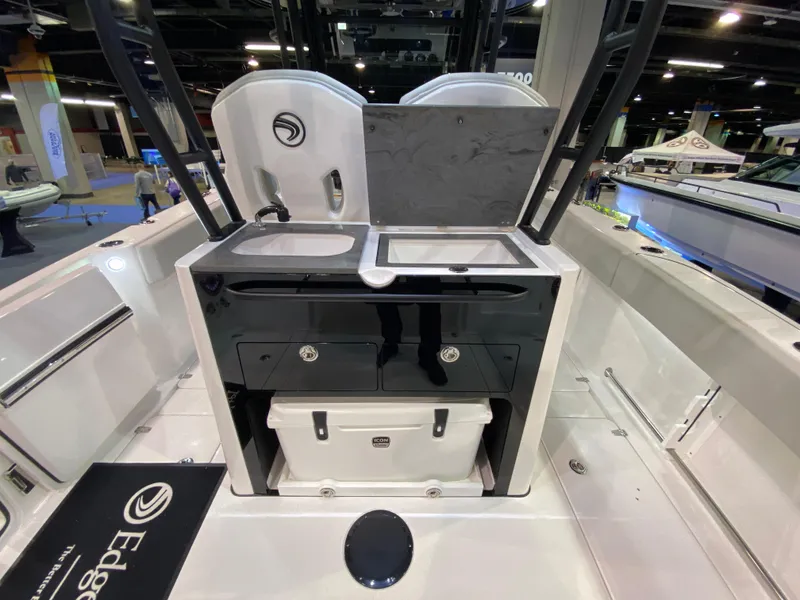 Slide: The Image of 2025 Edgewater 340CC boat interior with dual sinks and storage compartments. - 11