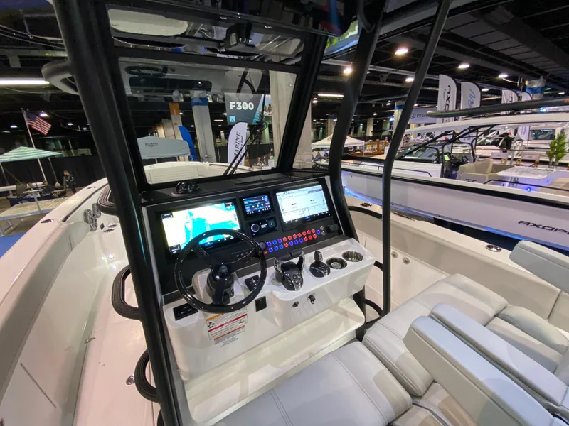 Slide: The Image of 2025 Edgewater 340CC boat cockpit with advanced navigation and control systems. - 16
