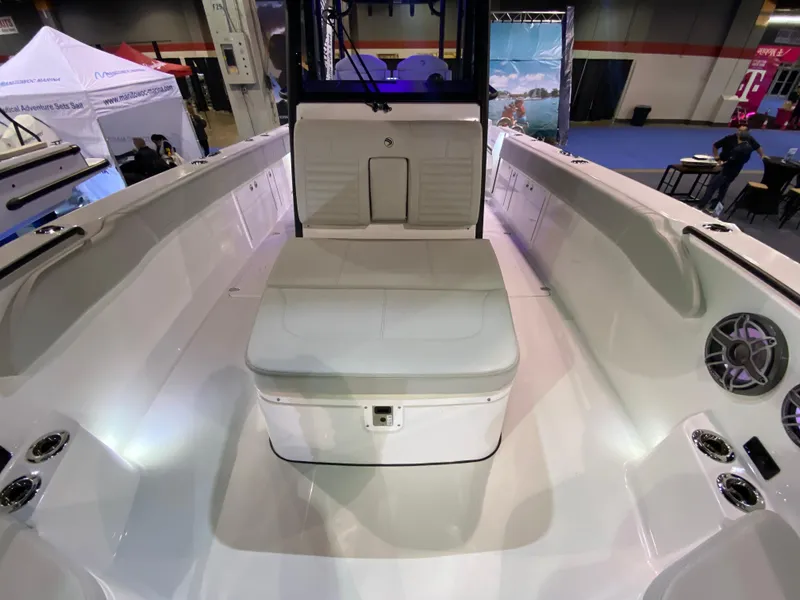 Slide: The Image of 2025 Edgewater 340CC boat interior with seating and speakers at a boat show. - 22