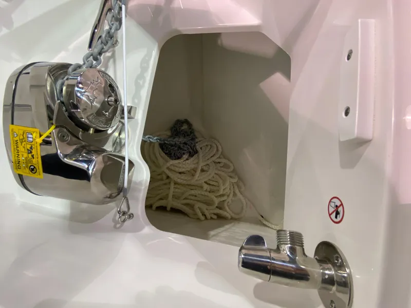 Slide: The Image of Anchor compartment of 2025 Edgewater 340CC boat with chain and rope storage. - 26