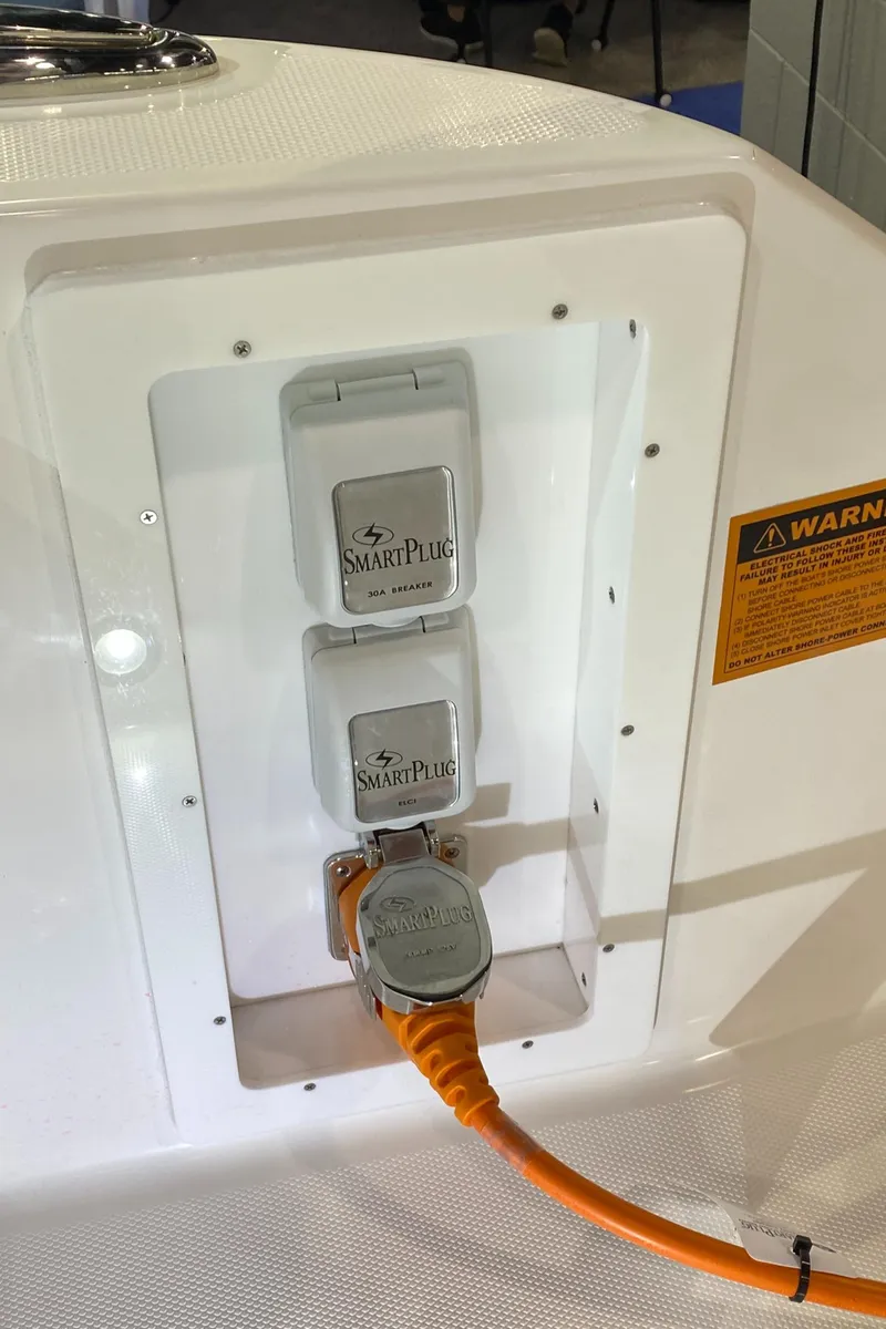 Slide: The Image of Edgewater 340CC 2025 boat with SmartPlug electrical connection and warning label. - 34