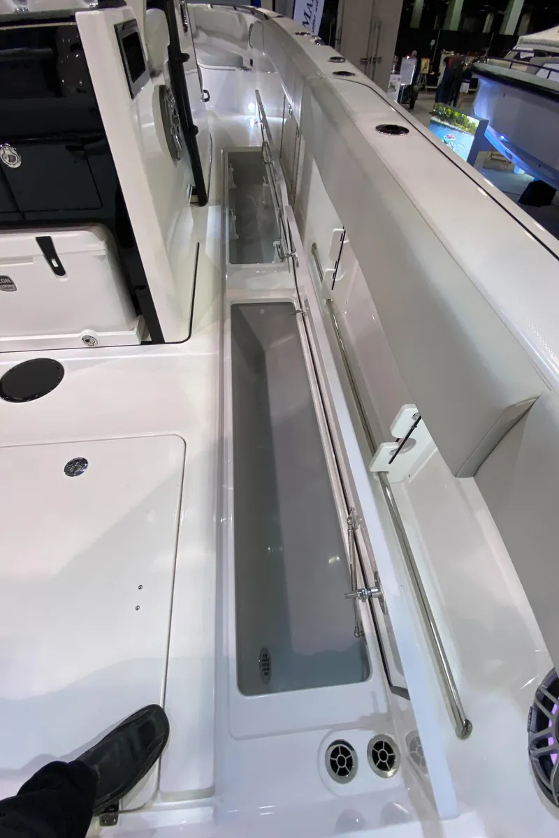 Slide: The Image of 2025 Edgewater 340CC boat interior with sleek white deck and storage compartments. - 35
