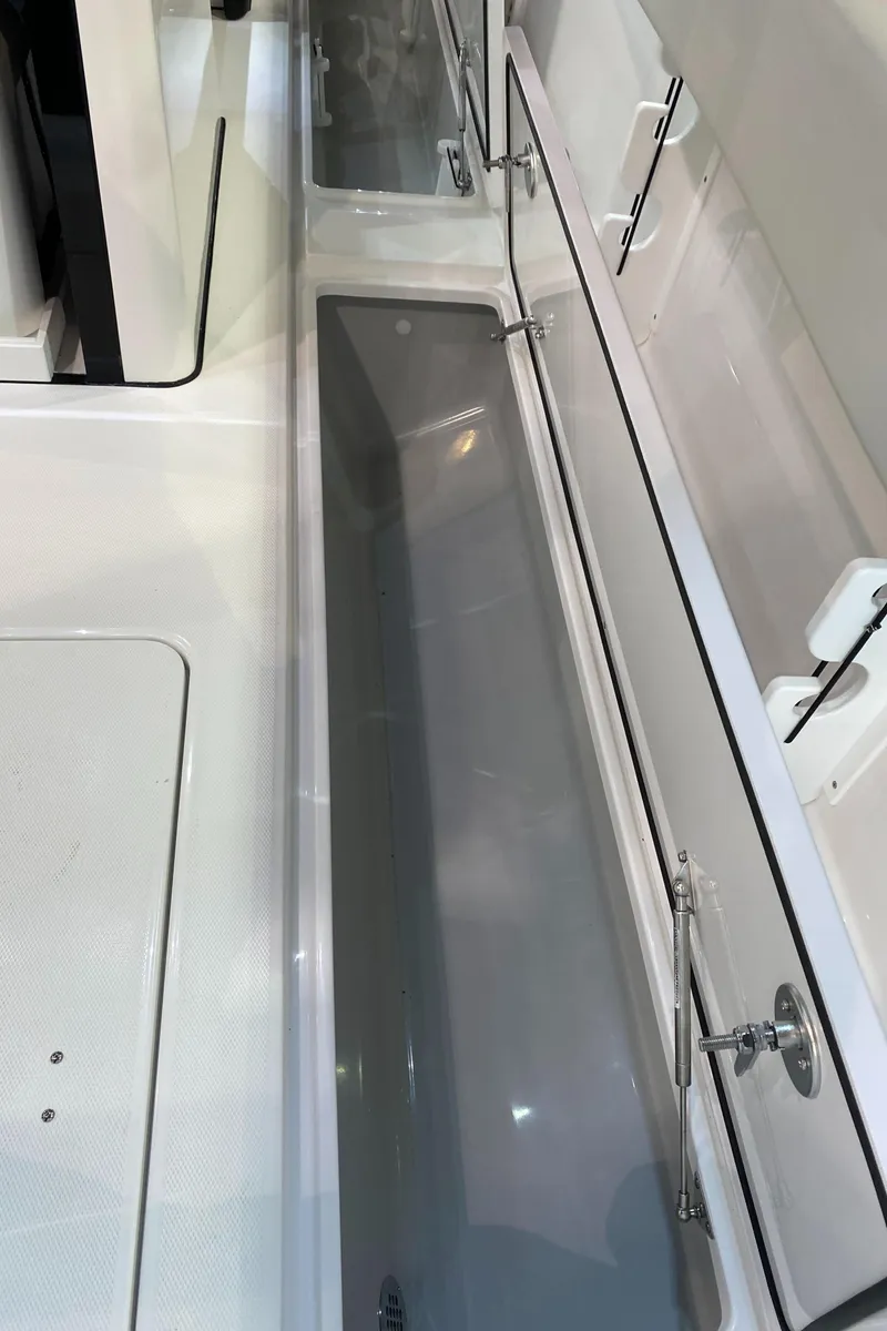 Slide: The Image of 2025 Edgewater 340CC boat interior storage compartment with sleek design and modern features. - 36