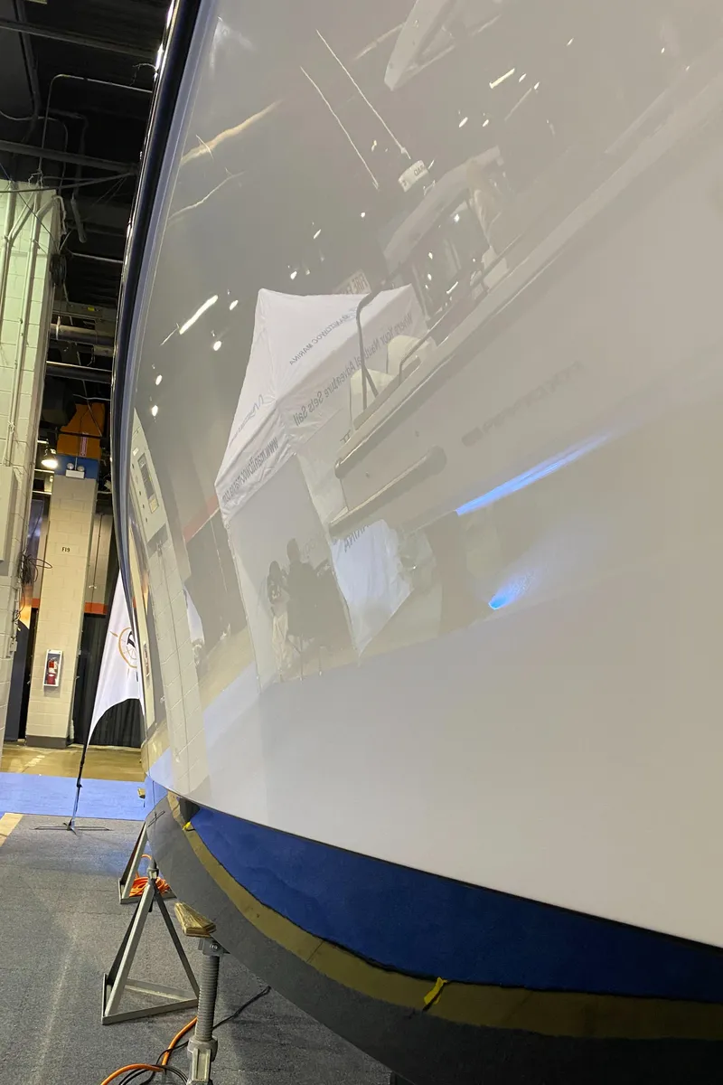 Slide: The Image of 2025 Edgewater 340CC boat hull displayed at an indoor exhibition. - 41