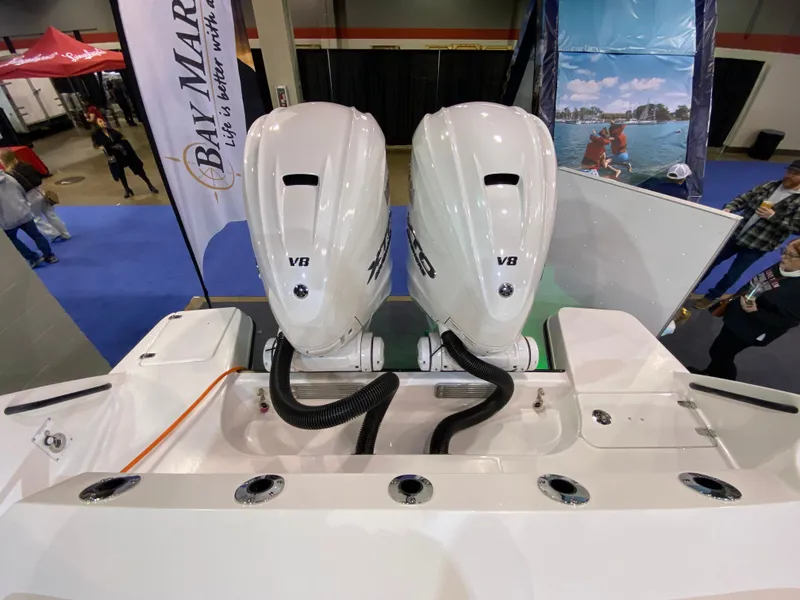 Slide: The Image of 2025 Edgewater 340CC boat with dual V8 engines displayed at a marine exhibition. - 7