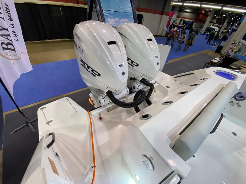 Slide: The Image of Edgewater 340CC 2025 boat with twin outboard engines at a boat show. - 8