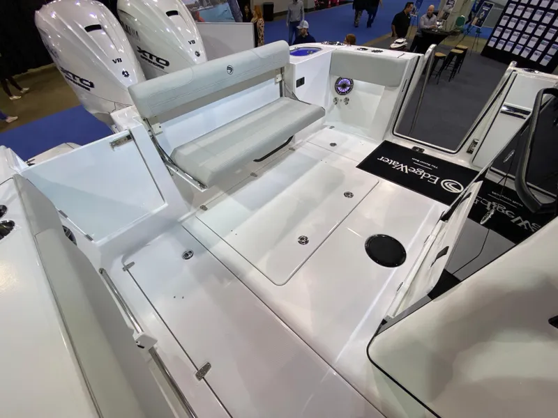 Slide: The Image of 2025 Edgewater 340CC boat interior with seating and dual outboard motors. - 9