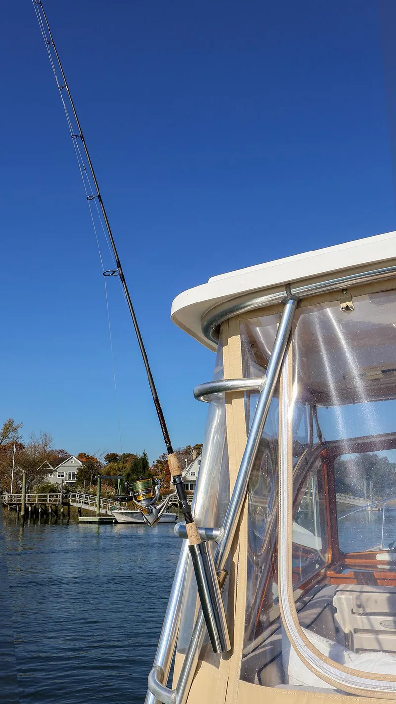 Slide: The Image of Fortier 33 boat, 2008 model, with fishing rod against clear blue sky. - 10