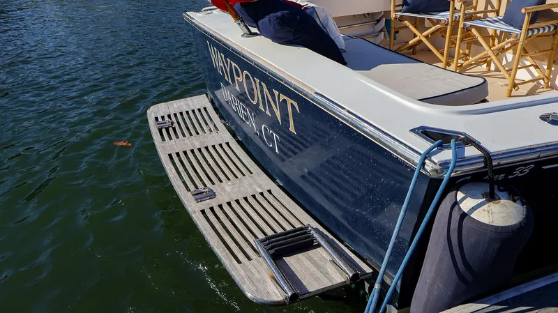 Slide: The Image of Fortier 33 boat, 2008 model, docked with visible swim platform and seating. - 13