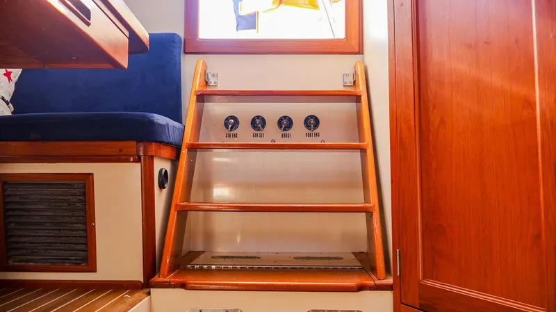 Slide: The Image of Interior of 2008 Fortier 33 boat with wooden steps and seating. - 19