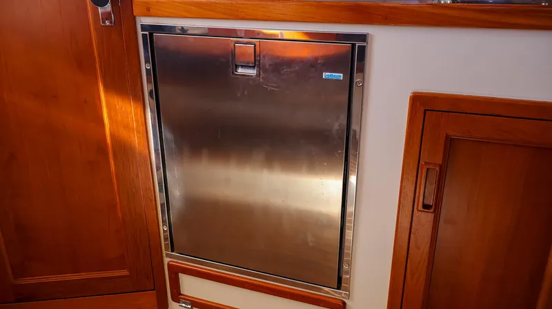 Slide: The Image of Stainless steel refrigerator in 2008 Fortier 33 boat interior with wooden cabinetry. - 22