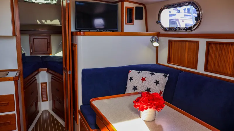 Slide: The Image of Interior of 2008 Fortier 33 boat with cozy seating and nautical decor. - 27