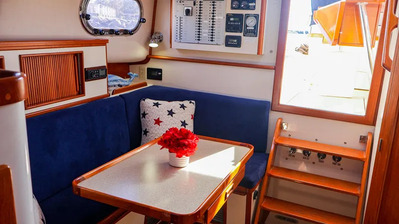 Slide: The Image of Interior of 2008 Fortier 33 boat with blue seating and table. - 28