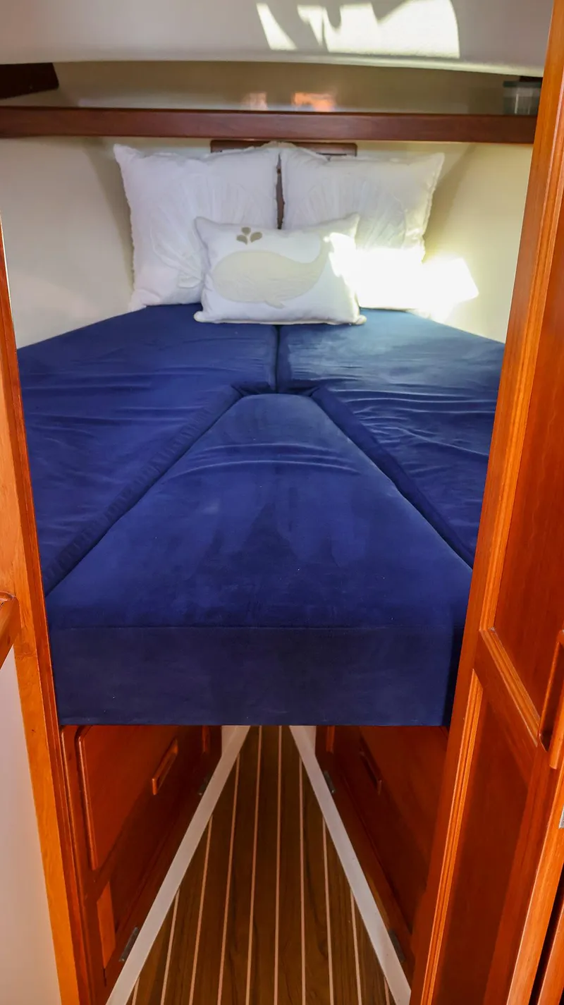Slide: The Image of Cozy cabin interior of 2008 Fortier 33 with blue bedding and wooden accents. - 31