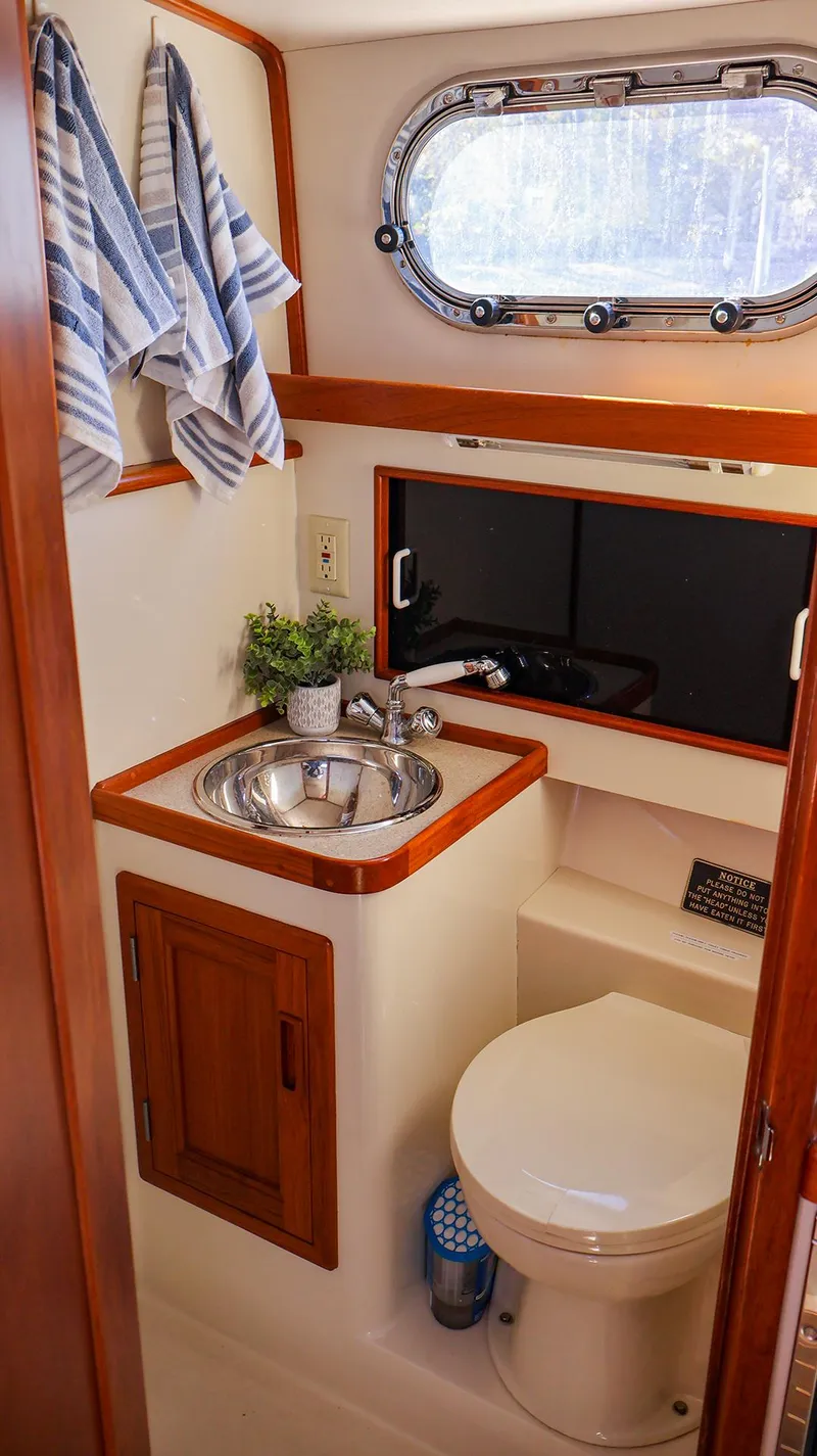 Slide: The Image of Compact bathroom in 2008 Fortier 33 boat with sink, toilet, and window. - 32