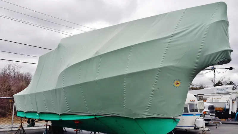 Slide: The Image of Fortier 33 boat, 2008 model, covered in green tarp, stored outdoors. - 34