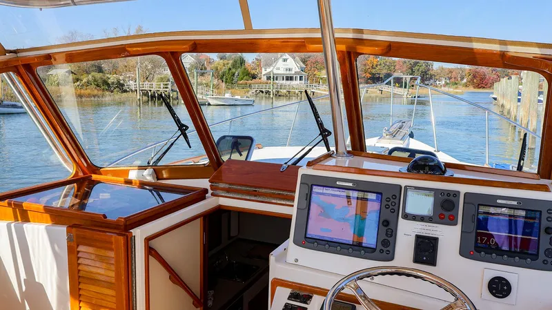 Slide: The Image of Interior view of 2008 Fortier 33 boat with navigation equipment and scenic waterway. - 7