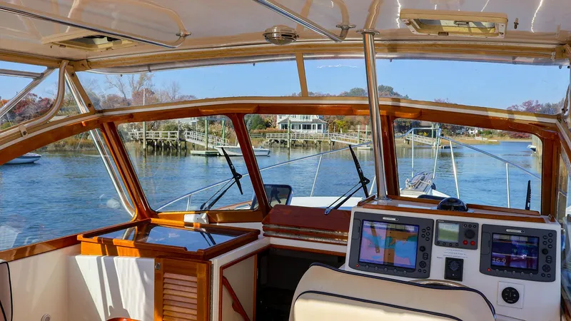 Slide: The Image of Interior view of 2008 Fortier 33 boat with navigation equipment and scenic waterway. - 8