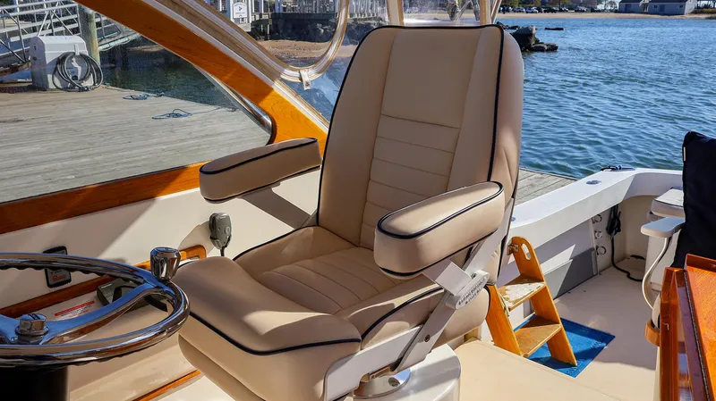Slide: The Image of Luxurious captain's chair on 2008 Fortier 33 boat, docked by serene waters. - 9