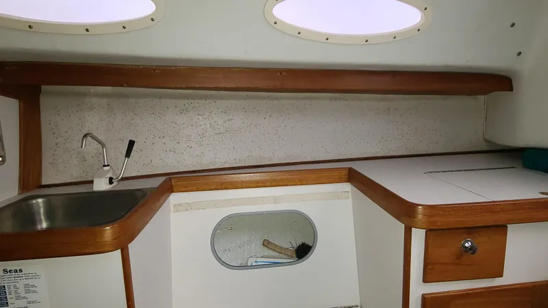 Slide: The Image of Interior of 2007 Alerion Express 28 sailboat with sink and wooden cabinetry. - 13