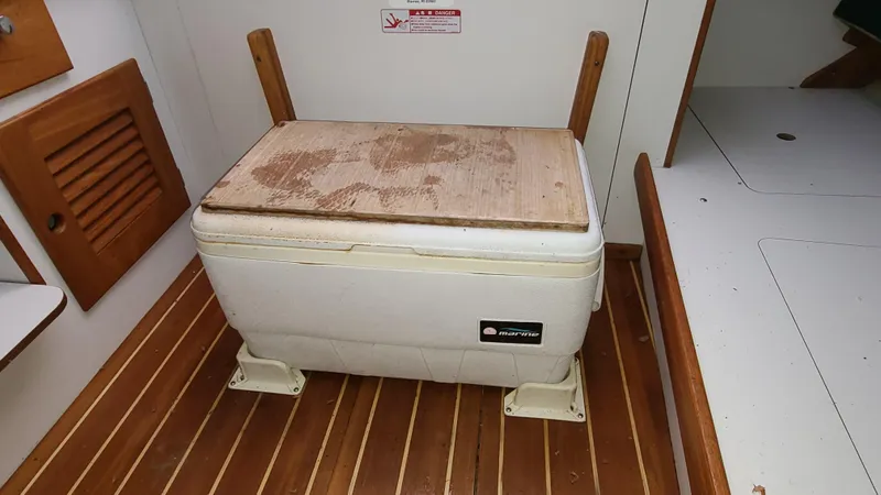 Slide: The Image of Wooden-floored interior of 2007 Alerion Express 28 with a mounted cooler. - 16