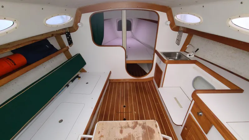Slide: The Image of Interior of 2007 Alerion Express 28 sailboat with wood accents and compact kitchenette. - 18