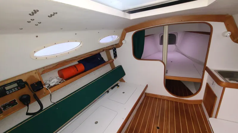Slide: The Image of Interior of 2007 Alerion Express 28 sailboat with wood accents and green seating. - 19
