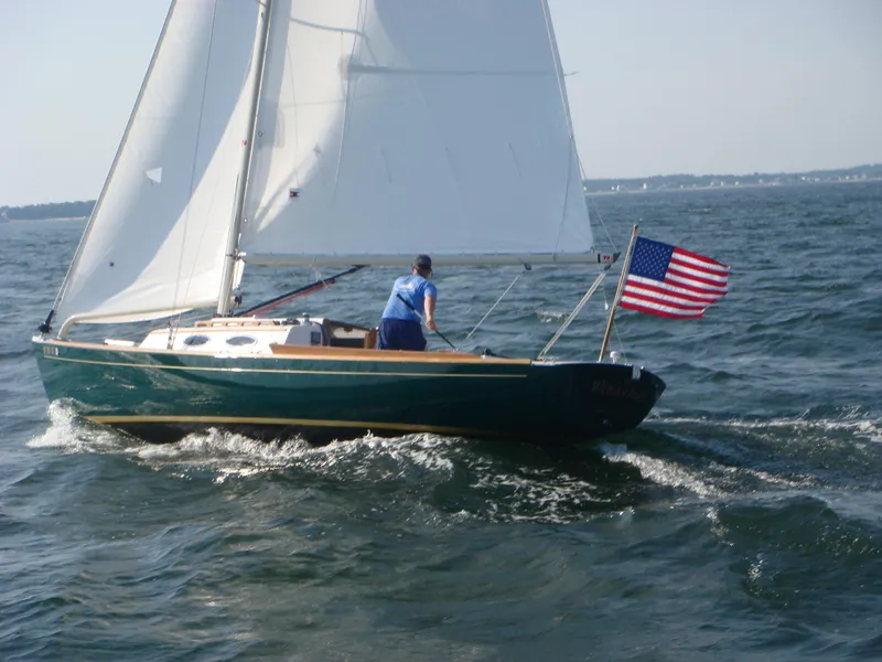Slide: The Image of Sailing Alerion Express 28, 2007 model, with American flag on open water. - 3