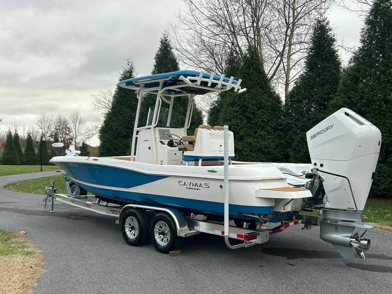 Slide: The Image of 2025 Caymas 26 HB boat on trailer with Mercury outboard motor. - 14