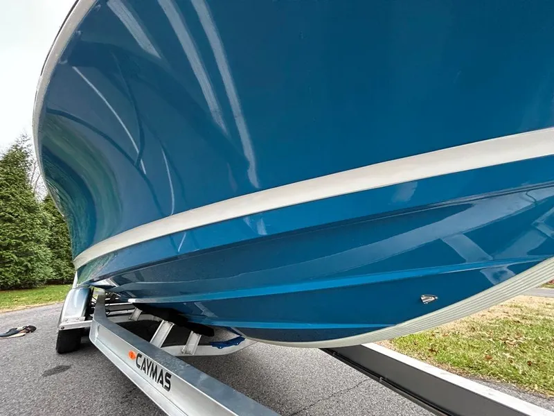 Slide: The Image of 2025 Caymas 26 HB boat on trailer, blue hull, outdoor setting. - 21