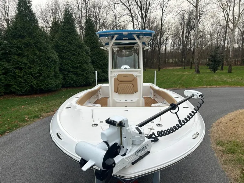 Slide: The Image of 2025 Caymas 26 HB boat on a driveway, surrounded by trees. - 22