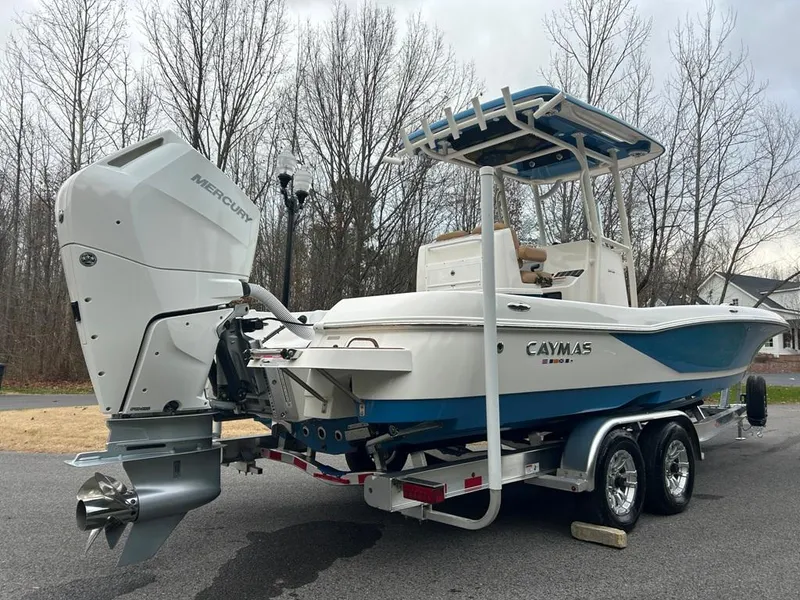 Slide: The Image of 2025 Caymas 26 HB boat on trailer with Mercury outboard motor. - 24
