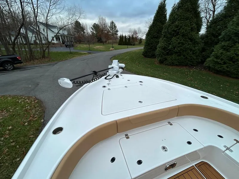 Slide: The Image of 2025 Caymas 26 HB boat on a suburban street, surrounded by trees. - 28