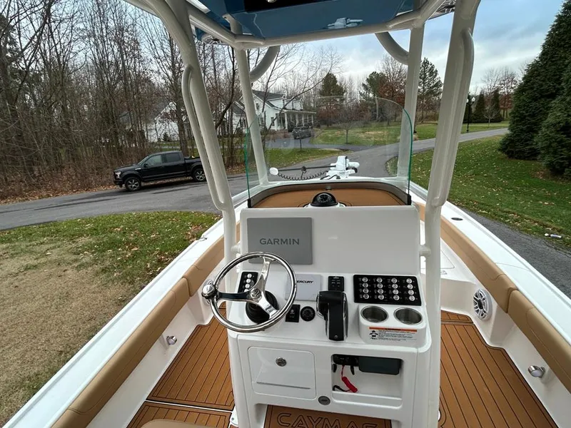 Slide: The Image of 2025 Caymas 26 HB boat cockpit with Garmin navigation system and steering wheel. - 32