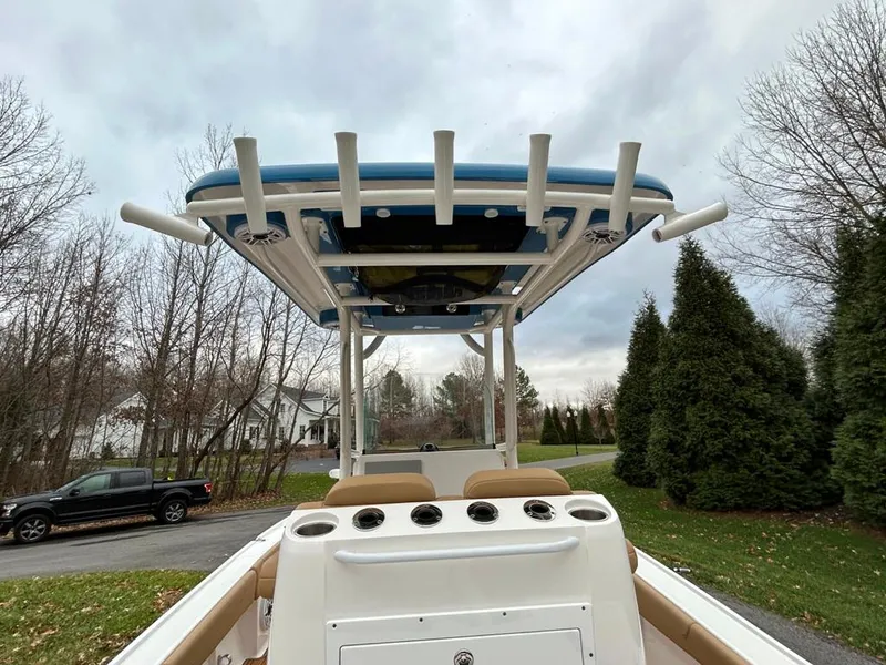 Slide: The Image of 2025 Caymas 26 HB boat with T-top, parked in a suburban driveway. - 35